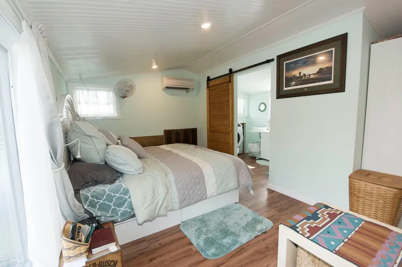Slide: The Image of 2017 Chesapeake 48 Houseboat bedroom with cozy decor and modern amenities. - 14