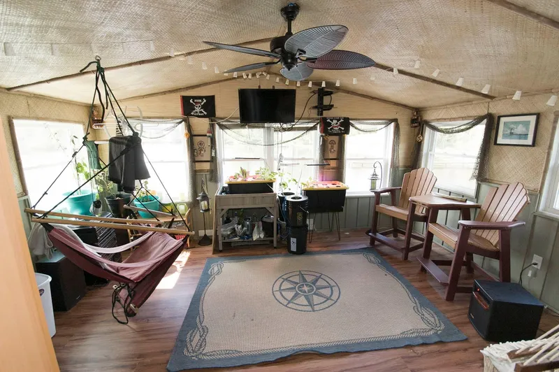 Slide: The Image of Interior of 2017 Chesapeake 48 Houseboat with hammock, chairs, and nautical decor. - 18