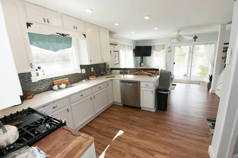 Slide: The Image of Modern kitchen interior of 2017 Chesapeake 48 Houseboat with white cabinets and wood flooring. - 7