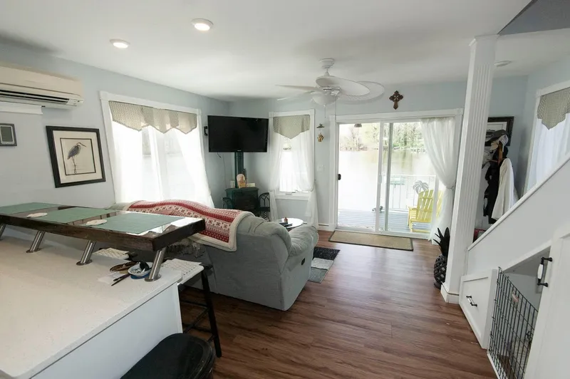 Slide: The Image of 2017 Chesapeake 48 Houseboat interior with cozy living area, large windows, and lake view. - 8