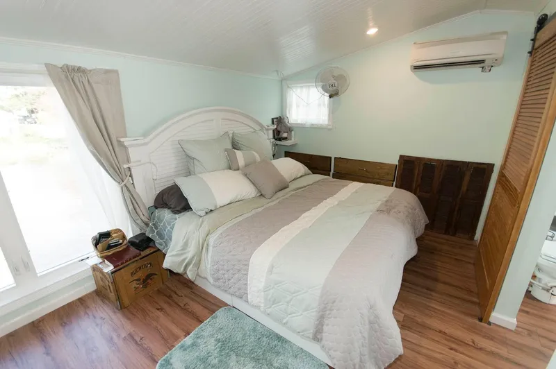 Slide: The Image of Cozy bedroom in a 2017 Chesapeake 48 Houseboat with a large bed and wooden flooring. - 9