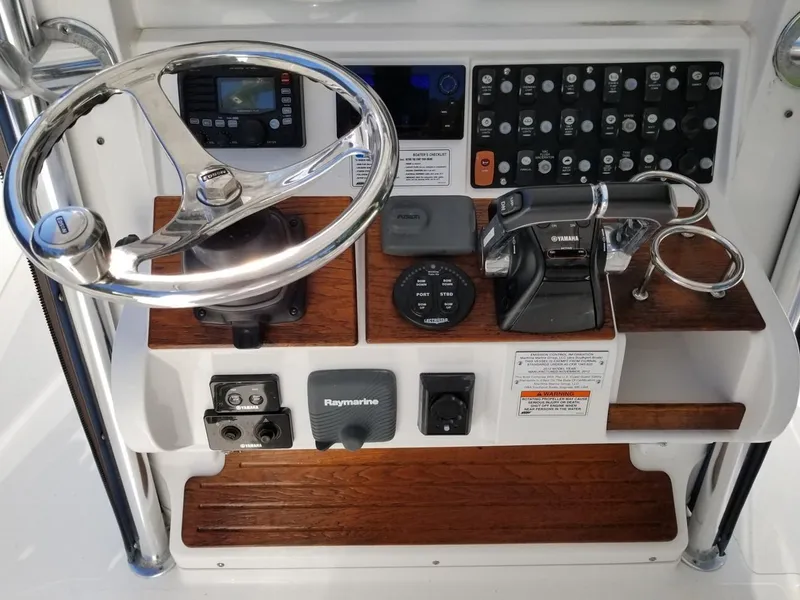 Slide: The Image of 2013 Southport 27 Center Console dashboard with steering wheel and control panel. - 11