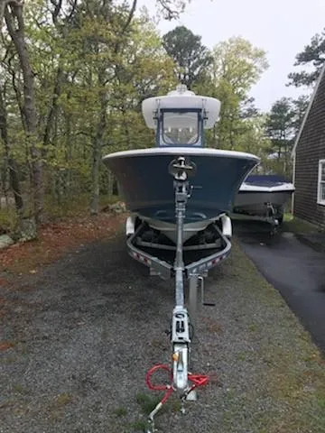 Slide: The Image of 2013 Southport 27 Center Console boat on trailer in wooded area. - 13