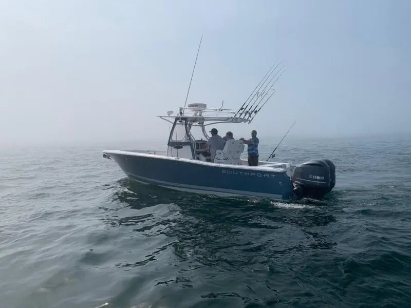 Slide: The Image of 2013 Southport 27 Center Console boat on open water with fishing rods. - 14