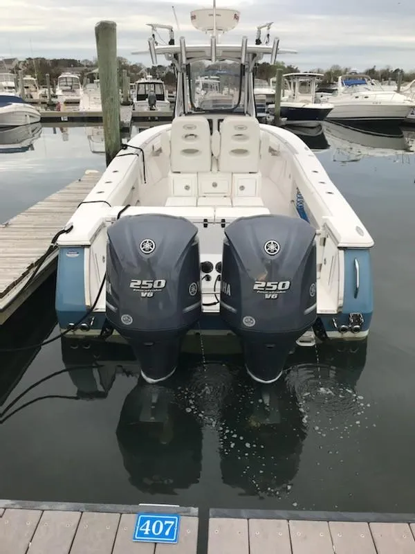 Slide: The Image of 2013 Southport 27 Center Console boat with twin Yamaha 250 engines docked at marina. - 15