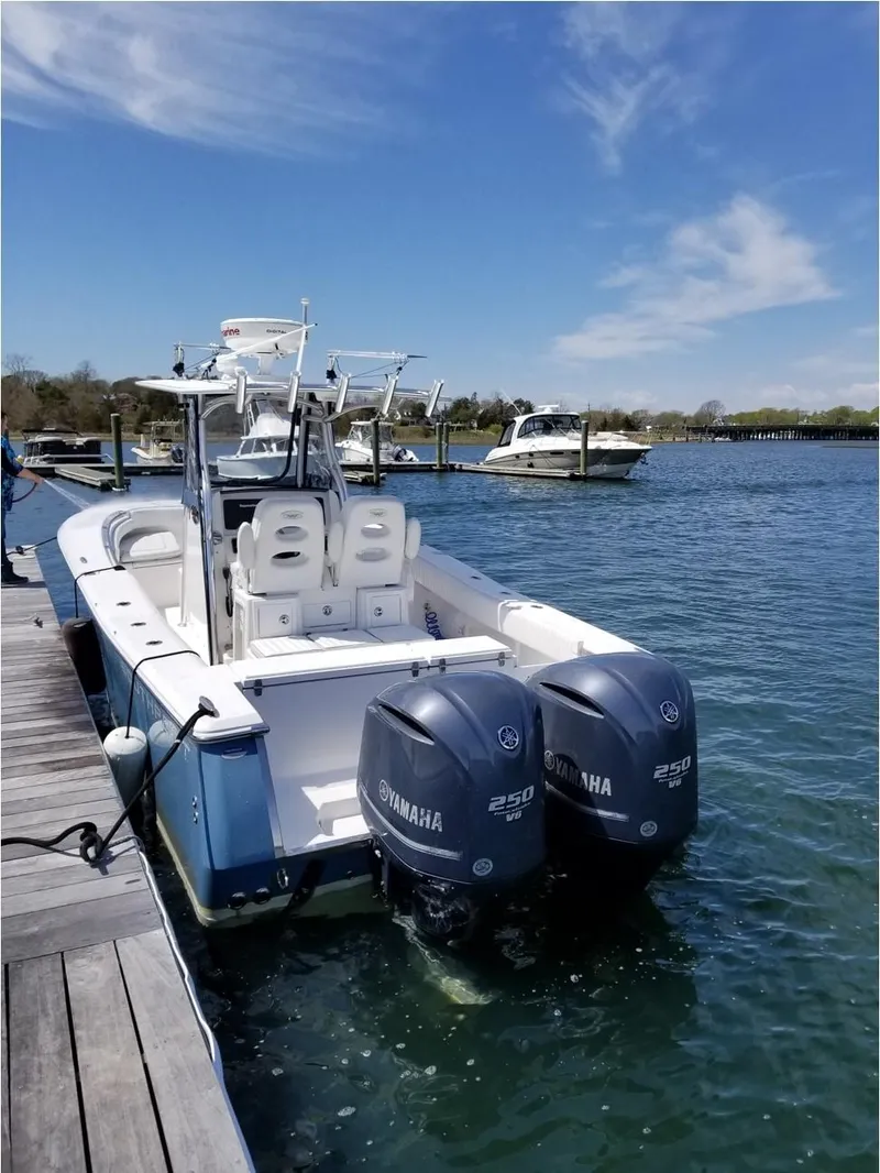 Slide: The Image of 2013 Southport 27 Center Console boat docked with twin Yamaha engines. - 7