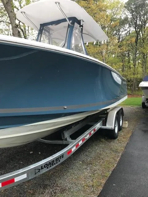 Slide: The Image of 2013 Southport 27 Center Console boat on Load Rite trailer, parked outdoors. - 8
