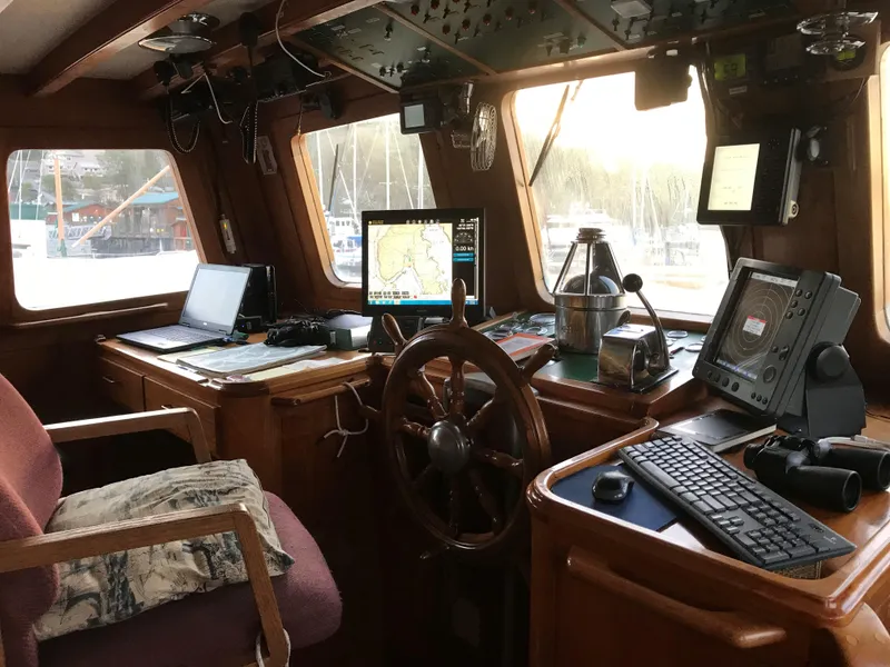 Slide: The Image of Pilothouse interior of 1971 Southern Marine MALAHIDE, featuring navigation equipment and wooden steering wheel. - 15