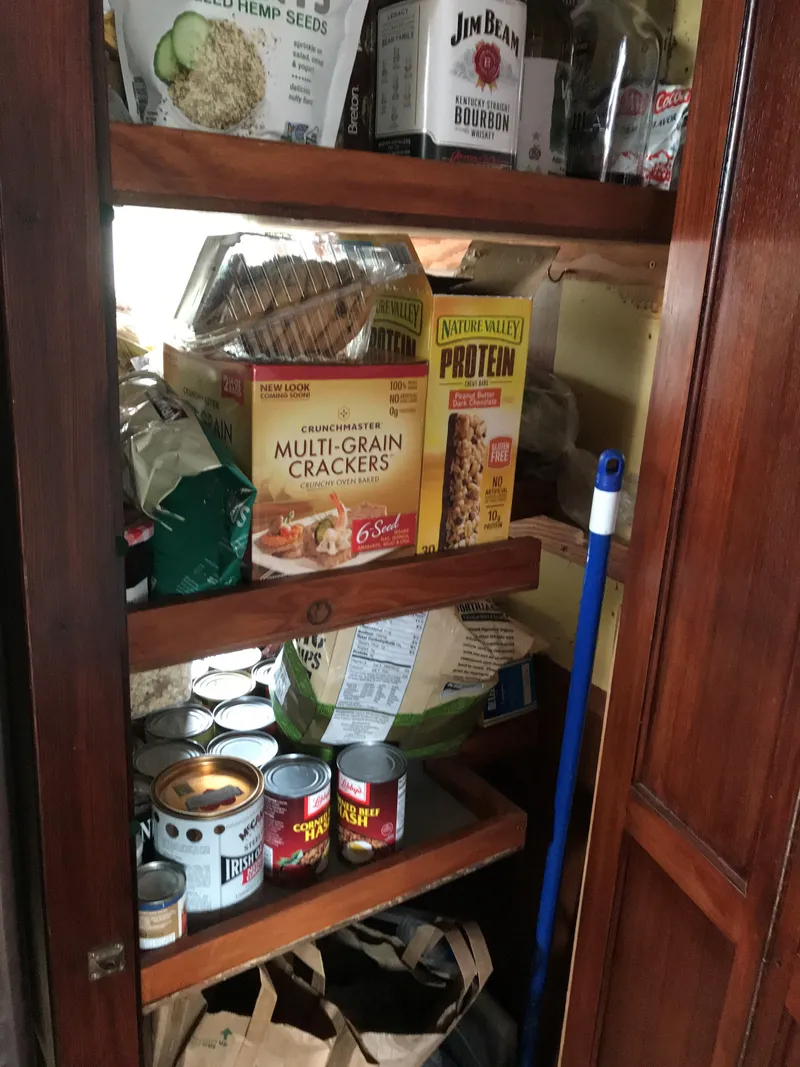 Slide: The Image of Pantry with assorted food items and cleaning supplies on a Southern Marine MALAHIDE Pilothouse LRC, 1971. - 18