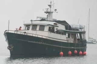Slide: The Image of 1971 Southern Marine MALAHIDE Pilothouse LRC boat on calm water with red buoys. - 2