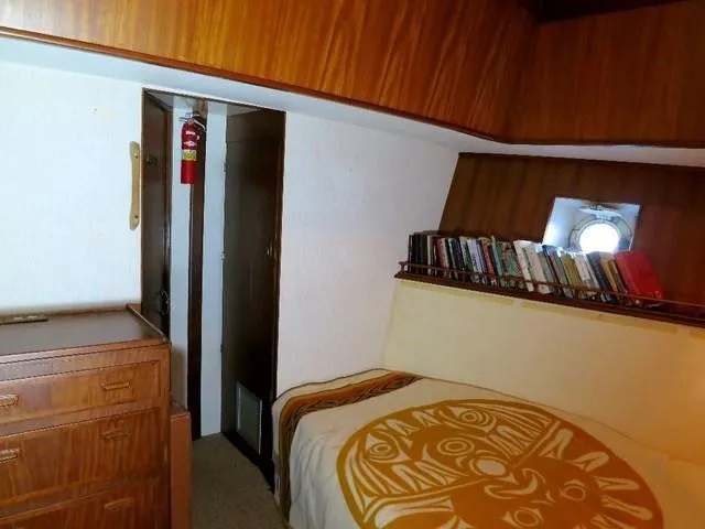 Slide: The Image of Cozy cabin interior of 1971 Southern Marine MALAHIDE Pilothouse LRC with wood paneling and porthole. - 23