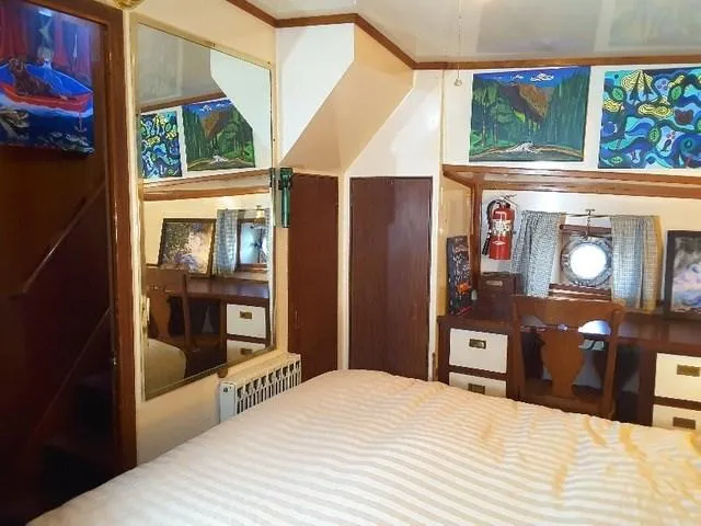 Slide: The Image of Interior of 1971 Southern Marine MALAHIDE Pilothouse LRC with bed, artwork, and porthole. - 25