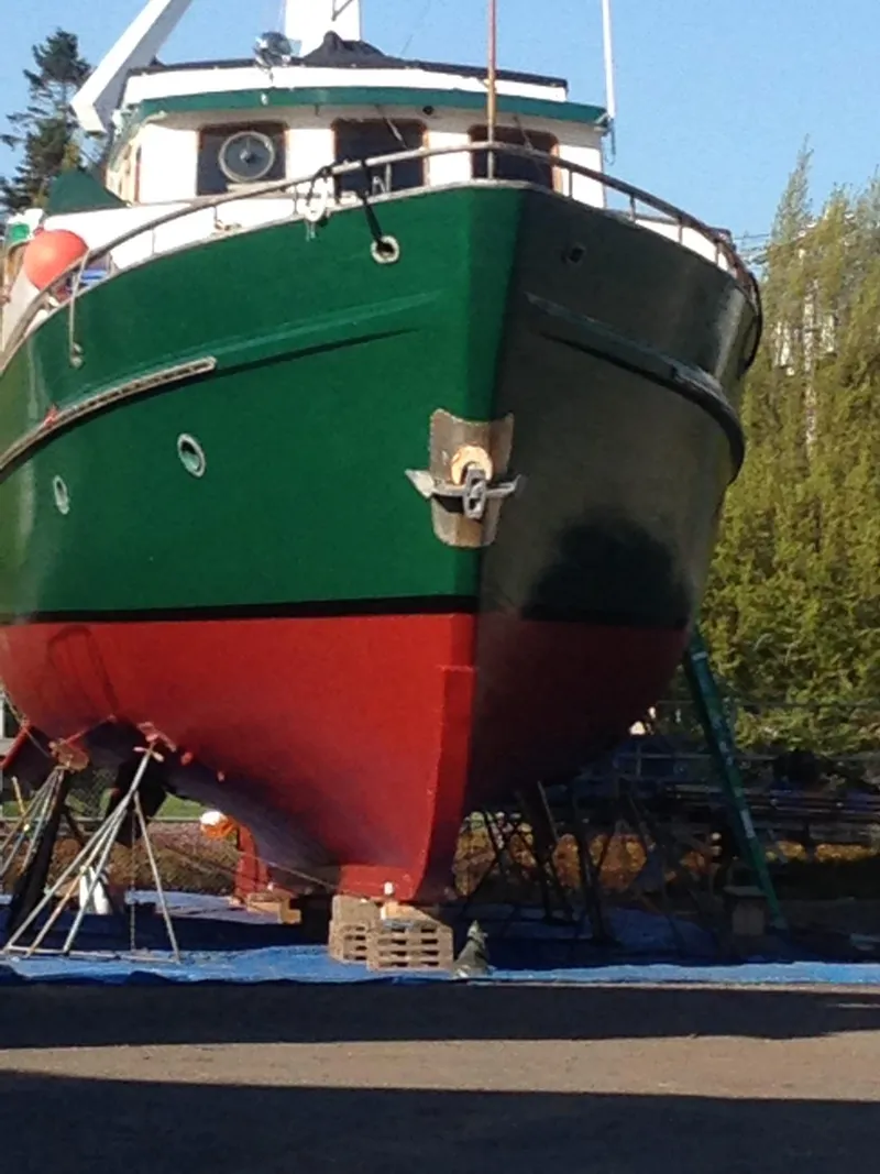 Slide: The Image of 1971 Southern Marine MALAHIDE Pilothouse LRC boat on dry dock, green and red hull. - 4