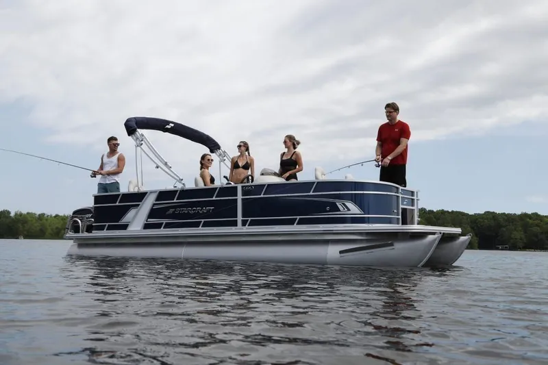 Slide: The Image of 2024 Starcraft 22 LX pontoon boat with people fishing on a lake. - 1