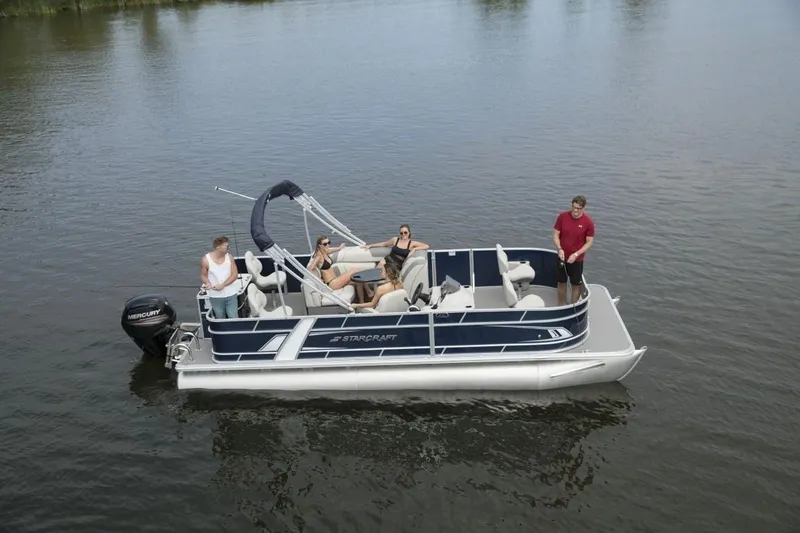 Slide: The Image of 2024 Starcraft 22 LX pontoon boat on a lake with passengers. - 3