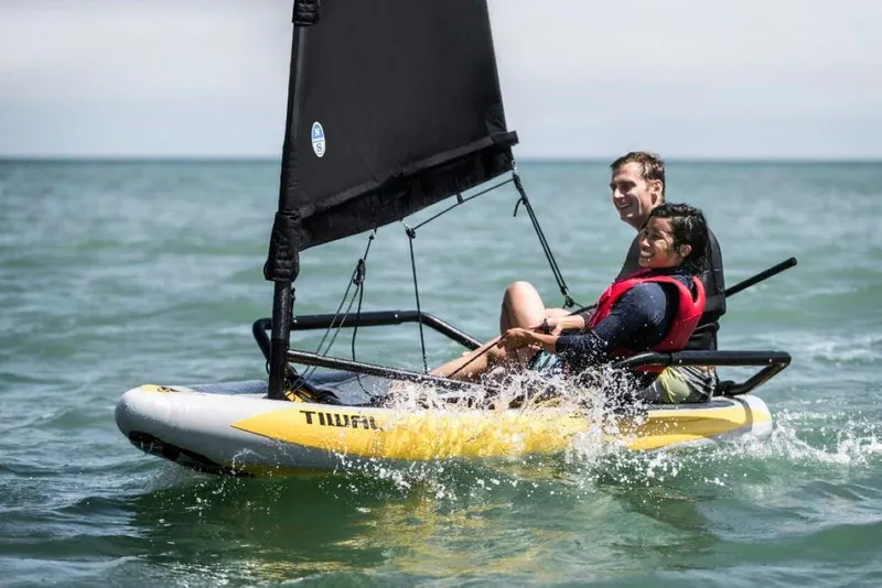 The Image of Two people sailing a 2022 Tiwal 3 sailboat on the ocean. - 0