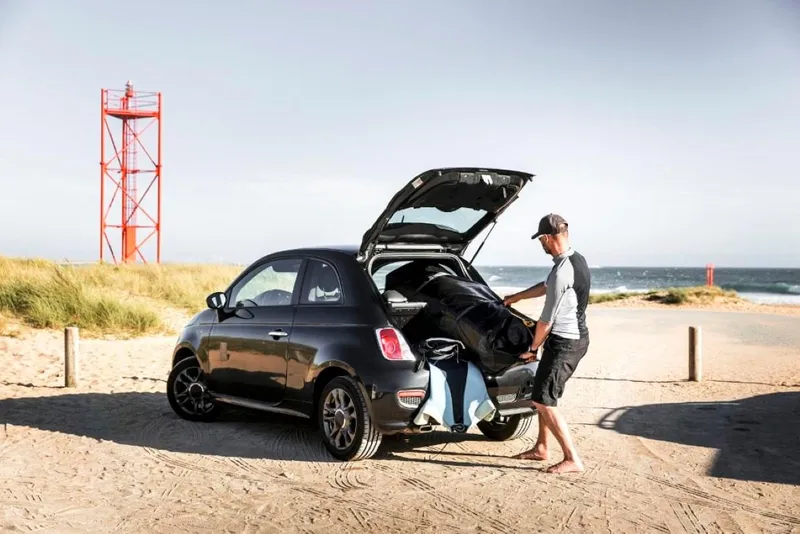 Slide: The Image of Man loading Tiwal 3 Sailboat into car trunk at beach, 2022 model. - 5