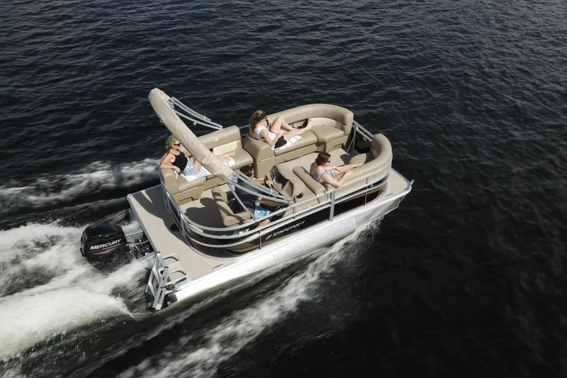 Slide: The Image of 2024 Starcraft LX 16 pontoon boat cruising on water with passengers. - 1
