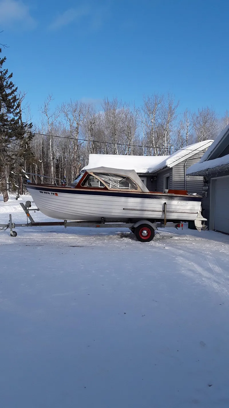 The Image of 1965 Thompson Sea Lancer boat on trailer in snowy driveway. - 0