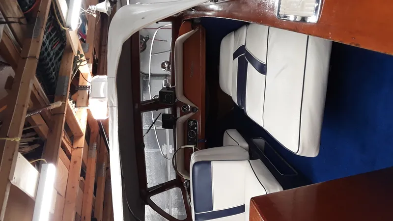 Slide: The Image of Interior of a 1965 Thompson Sea Lancer boat with white and blue seating. - 7