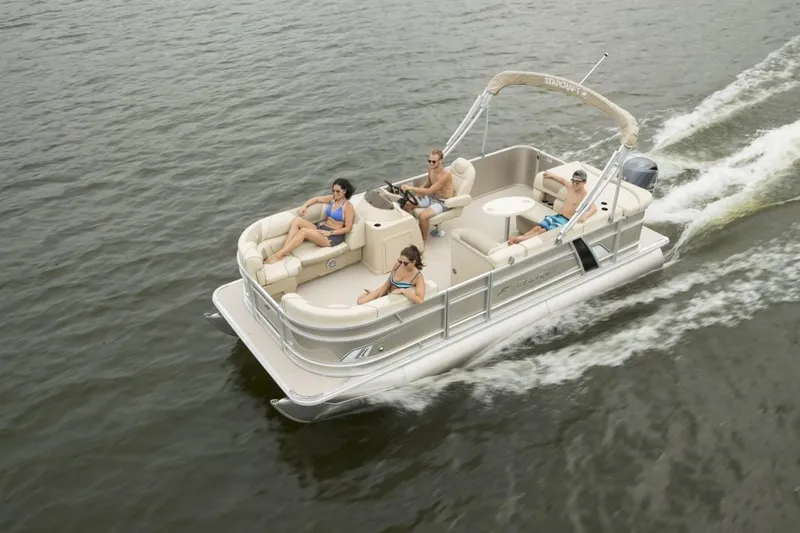 Slide: The Image of 2024 Starcraft EX 20 pontoon boat cruising on a lake with passengers. - 6