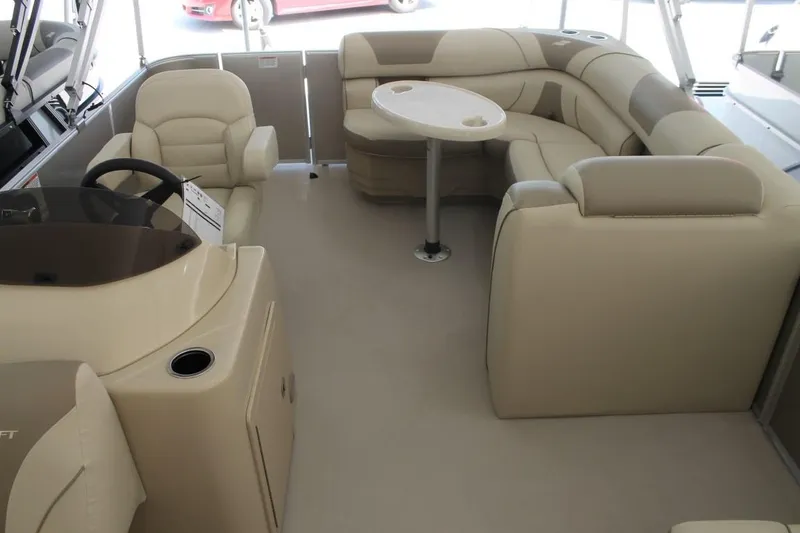 Slide: The Image of 2023 Starcraft EX 18 boat interior with beige seating and a round table. - 12