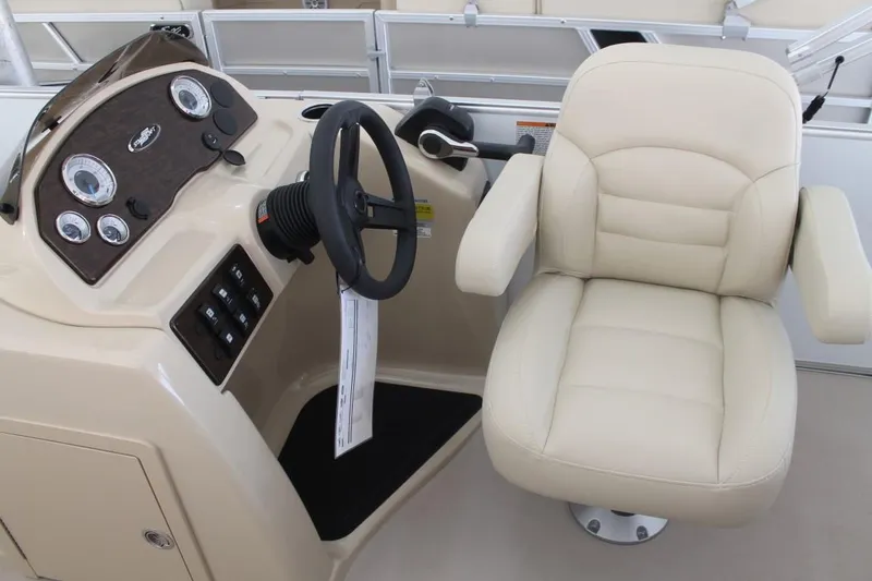 Slide: The Image of 2023 Starcraft EX 18 boat helm with beige captain's chair and control panel. - 14