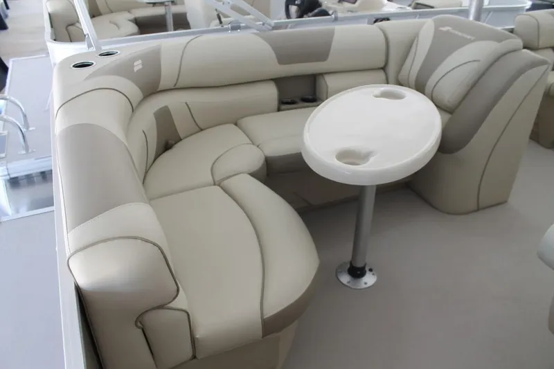 Slide: The Image of 2023 Starcraft EX 18 boat interior with beige seating and round table. - 17