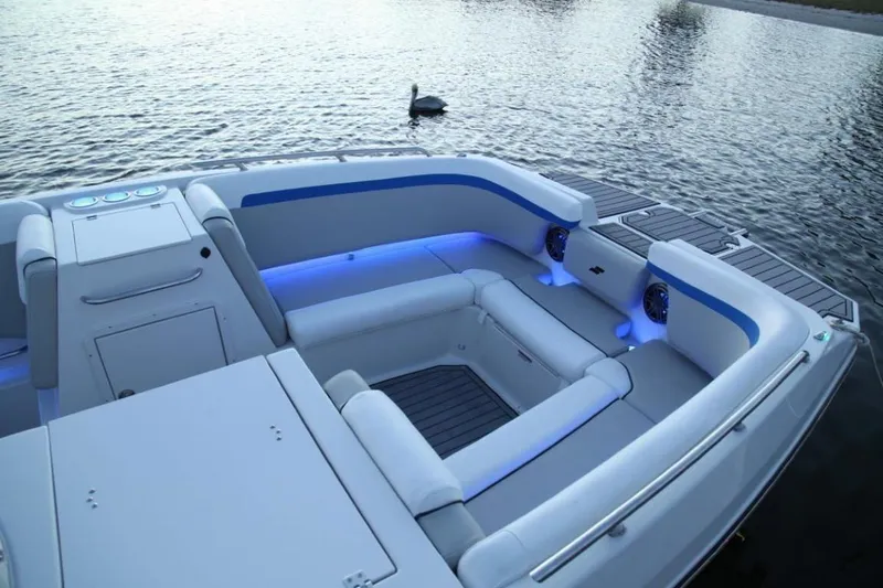 Slide: The Image of 2024 Starcraft 231 SVX boat interior with blue LED lighting on the water. - 8