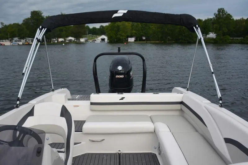 Slide: The Image of 2023 Starcraft 211 SVX boat with Suzuki 200 motor on a lake. - 10