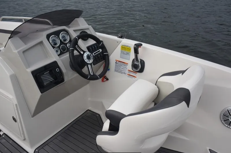 Slide: The Image of 2023 Starcraft 211 SVX boat cockpit with steering wheel and control panel. - 11