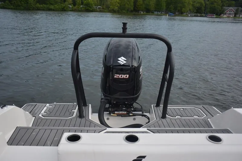 Slide: The Image of 2023 Starcraft 211 SVX boat with Suzuki 200 outboard motor on a lake. - 15