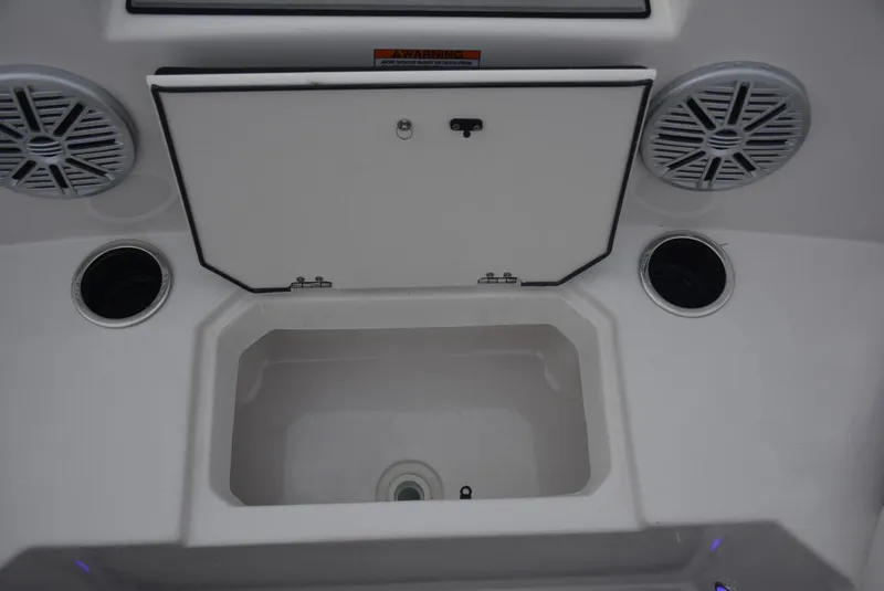 Slide: The Image of 2024 Starcraft SVX 171 boat storage compartment with speakers and cup holders. - 7
