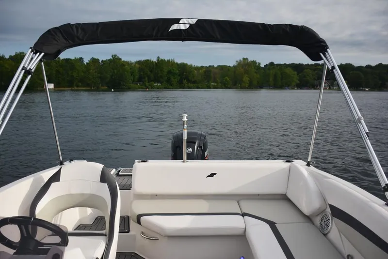 Slide: The Image of 2024 Starcraft SVX 171 boat interior with lake view and lush green shoreline. - 9