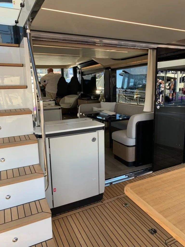 Slide: The Image of 2024 Absolute 58 Navetta yacht interior with modern seating and wooden flooring. - 15