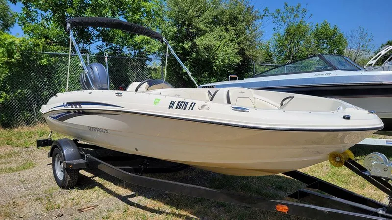 Slide: The Image of 2020 Stingray 182SC boat on trailer, parked outdoors. - 14