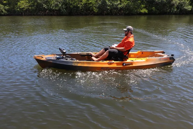 Slide: The Image of 2023 Old Town Sportsman Autopilot 136 kayak on a calm river. - 20