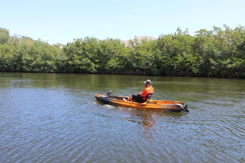 Slide: The Image of Person kayaking on a river in an Old Town Sportsman Autopilot 136, 2023 model. - 23