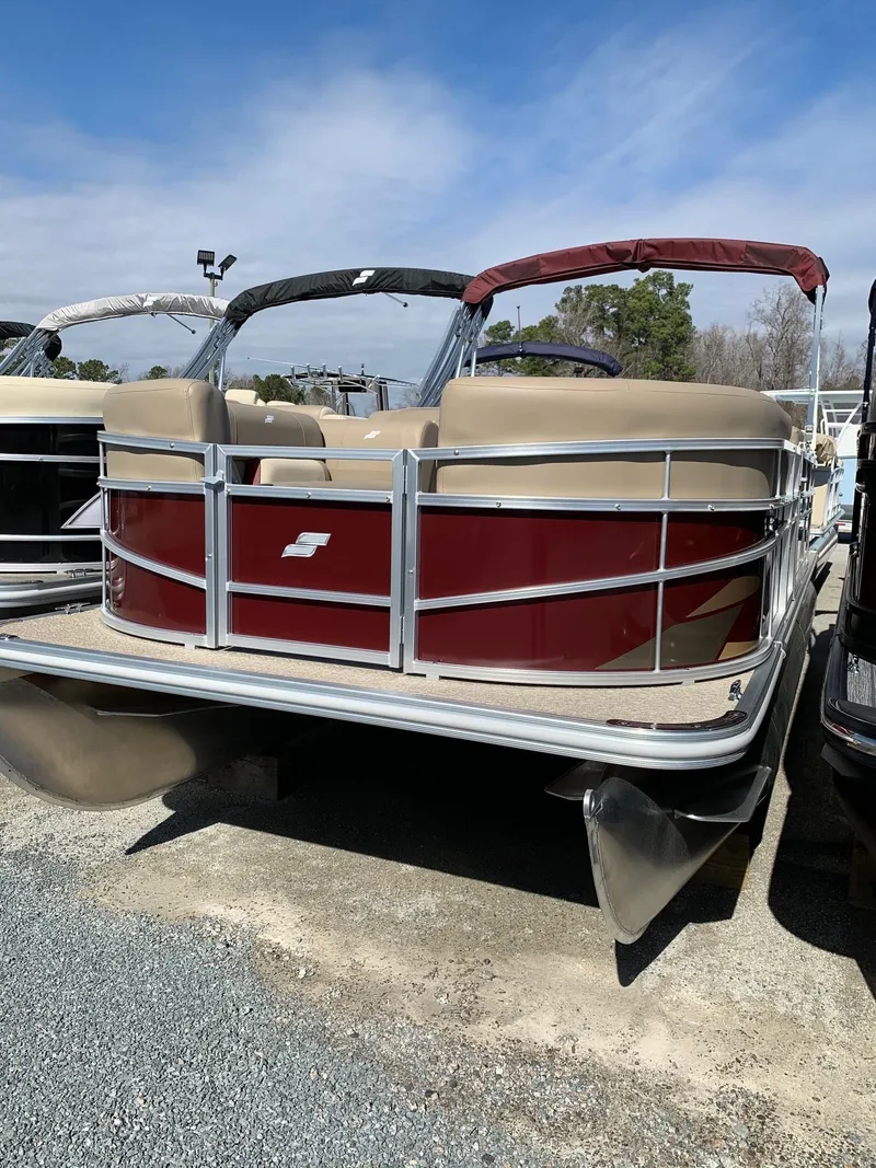 Slide: The Image of 2024 Starcraft LX20R pontoon boat with red and beige design. - 1