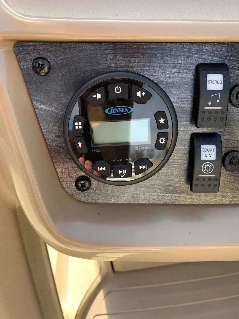 Slide: The Image of Control panel of 2024 Starcraft LX20R boat with Jensen stereo system. - 11