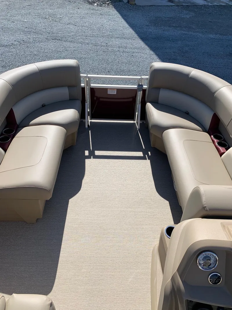 Slide: The Image of 2024 Starcraft LX20R pontoon boat with beige seating and spacious deck. - 5