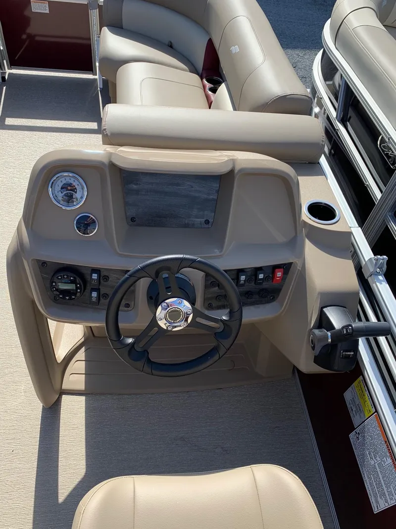 Slide: The Image of 2024 Starcraft LX20R boat dashboard with steering wheel and control panel. - 10