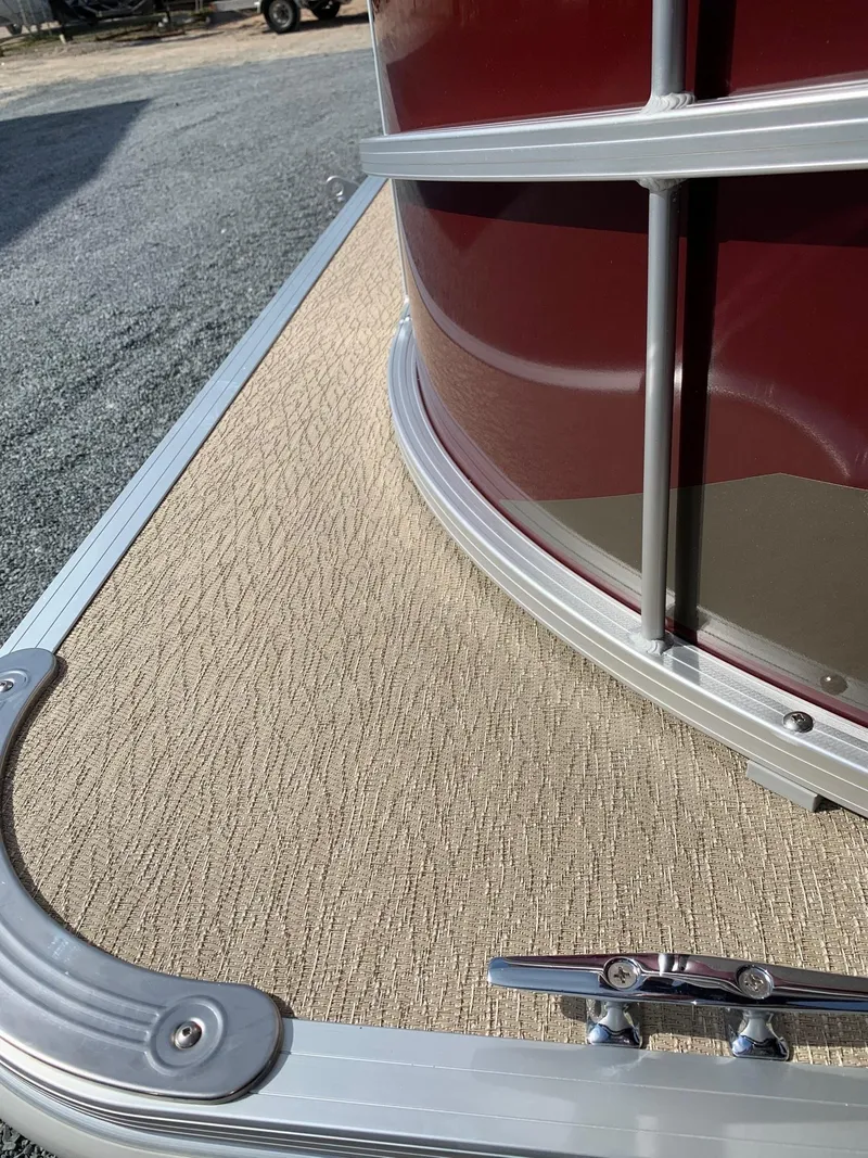 Slide: The Image of 2024 Starcraft LX20R pontoon boat with beige deck and red exterior. - 13