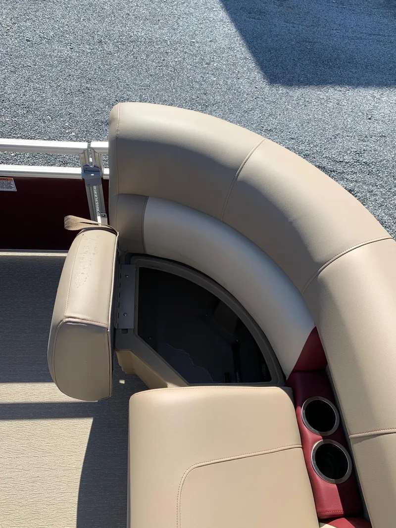 Slide: The Image of 2024 Starcraft LX20R boat with beige seating and cup holders. - 6