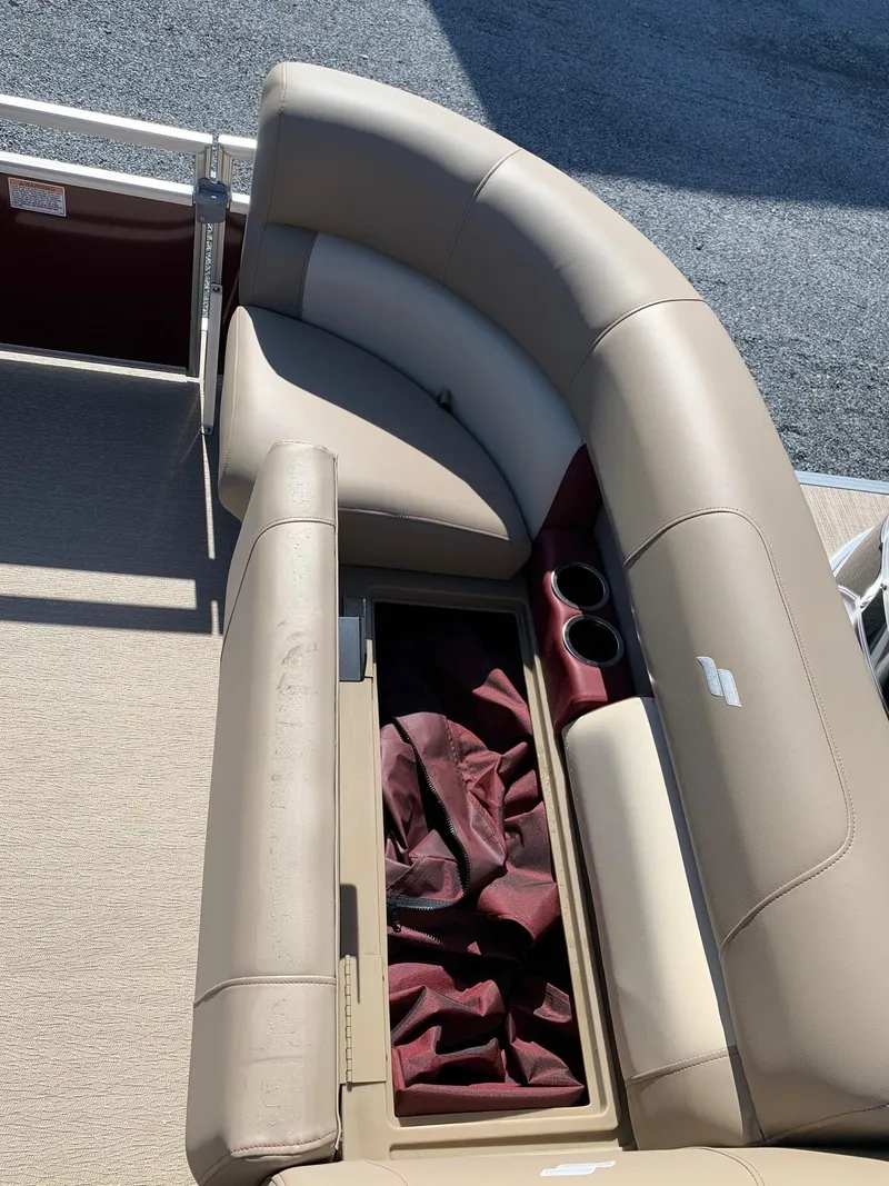 Slide: The Image of 2024 Starcraft LX20R boat with beige seating and storage compartment. - 7