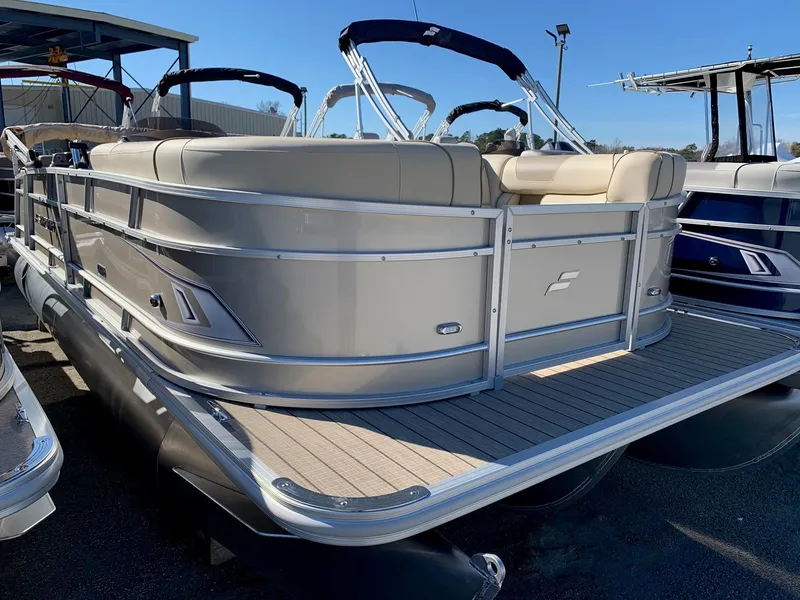 The Image of 2024 Starcraft EX22Q pontoon boat with beige seating and aluminum railing. - 1