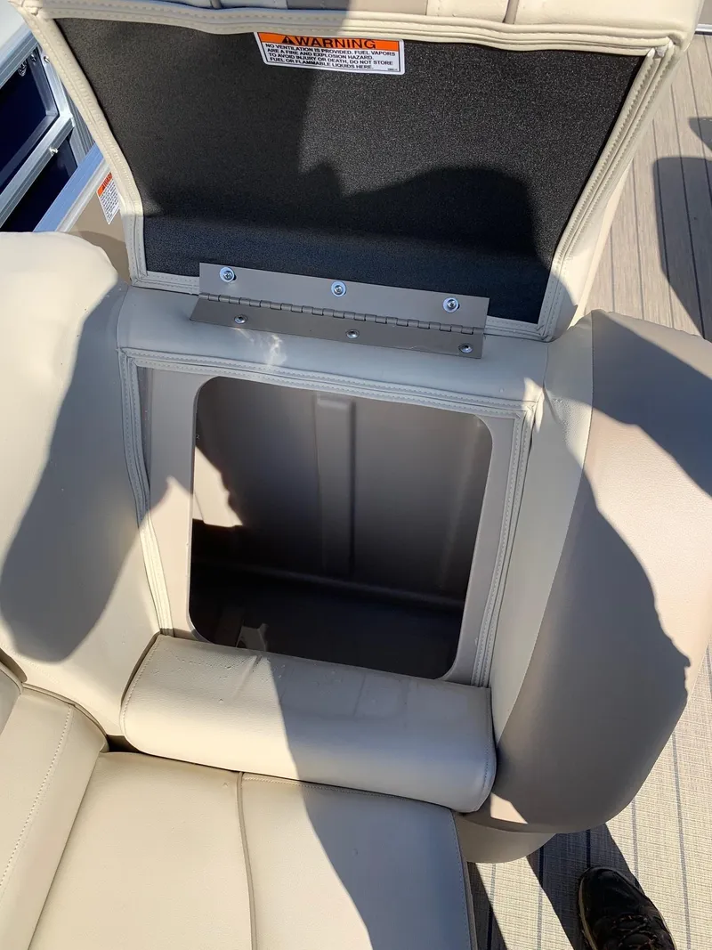 Slide: The Image of 2024 Starcraft EX22Q boat seat storage compartment open. - 14