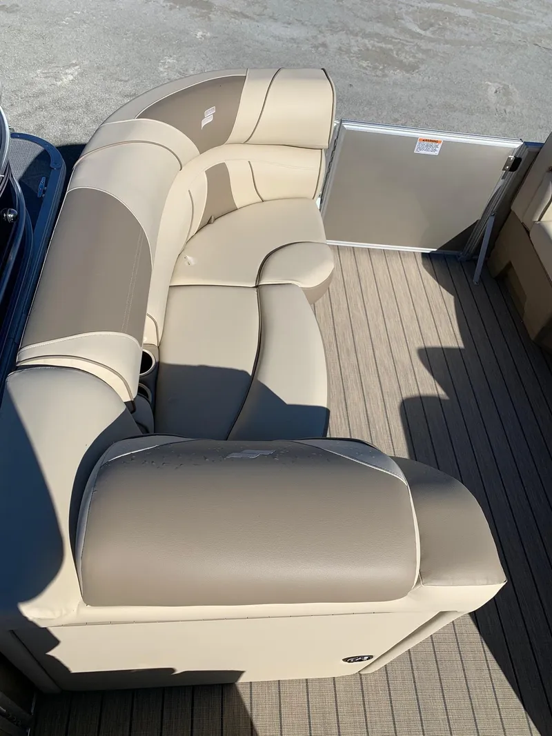 Slide: The Image of 2024 Starcraft EX22Q pontoon boat with beige and tan seating. - 11