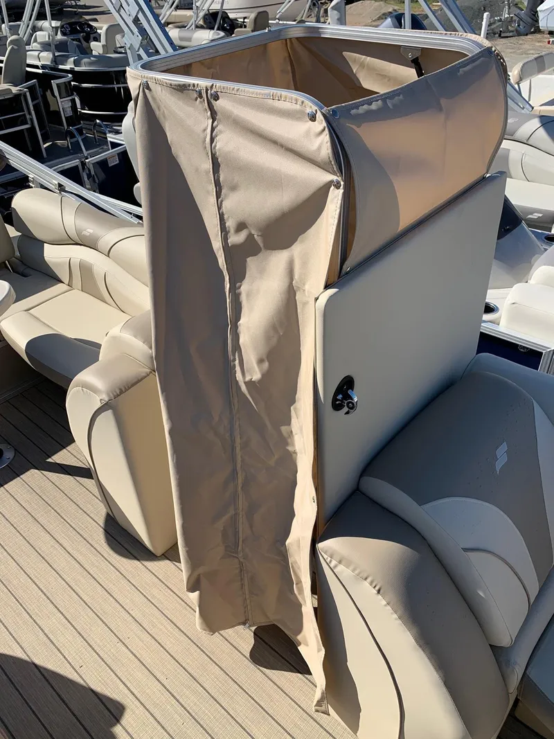 Slide: The Image of 2024 Starcraft EX22Q pontoon boat with beige seating and privacy enclosure. - 15