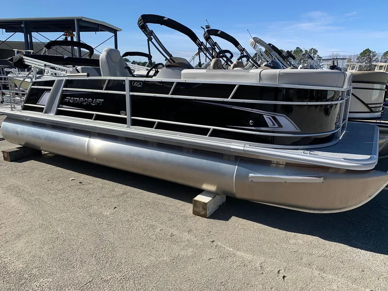 The Image of 2024 Starcraft EX22Q pontoon boat on display at a marina. - 0